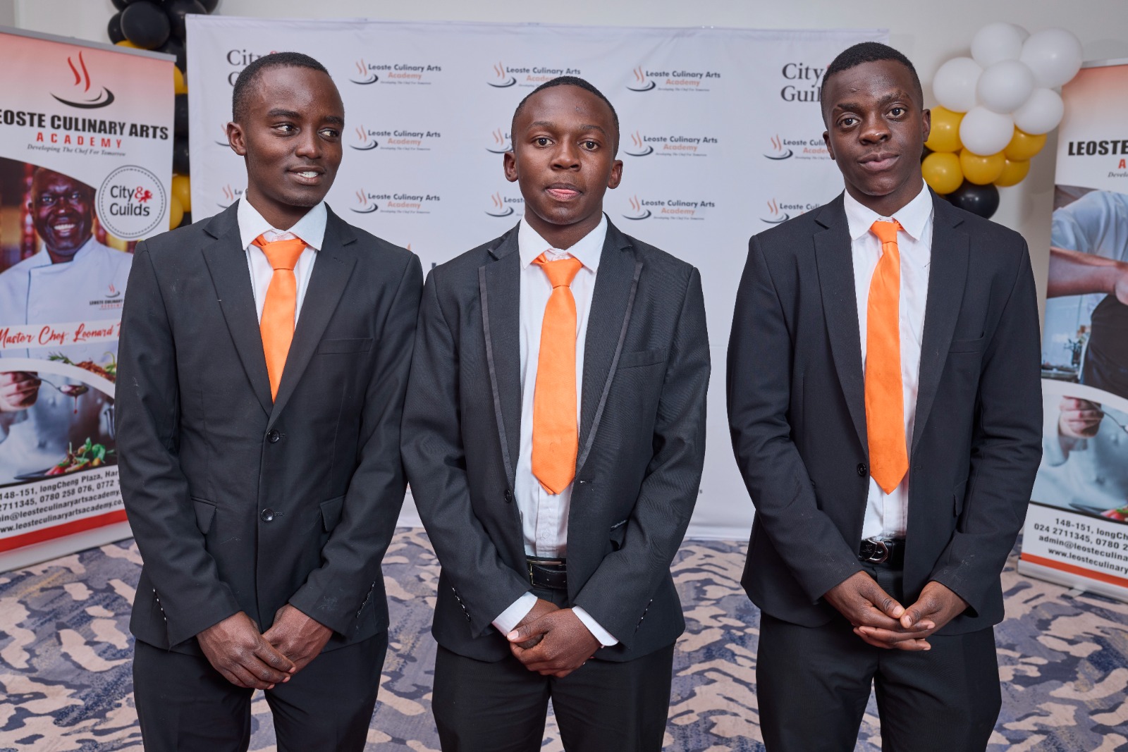 Professional male graduates in formal attire